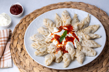 Traditional manti food on plate, top view. The concept of oriental cuisine. Uzbek food manty...