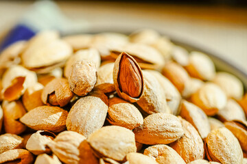Close up a pile of almonds on the indoor table