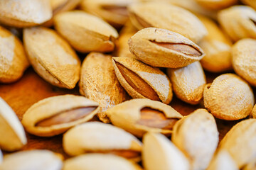 Close up a pile of almonds on the indoor table