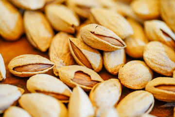 Close up a pile of almonds on the indoor table