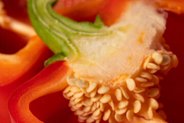 Red bell pepper in section close-up on a white background
