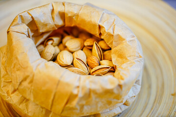 Close up a pile of almonds on the indoor table