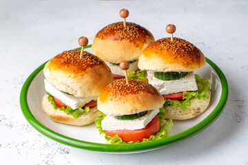 Mini sandwiches with feta cheese, tomato and cucumber.