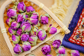 Fototapeta na wymiar Many naturally dried rose buds on the table