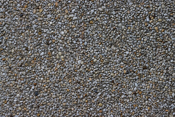 Small pebbles in concrete wall for background