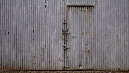 worn metal door from factory as background