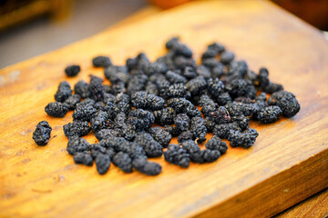 There are many naturally dried black wolfberries on the table