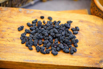 There are many naturally dried black wolfberries on the table
