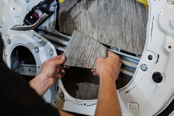 Car tuning. Sound insulation of the car. Installation of sound insulation material on the car....