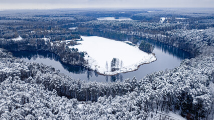 Snowy forest, cold winter river in winter.