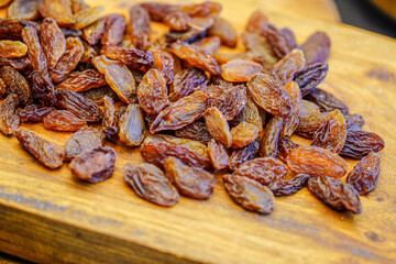 There are many naturally dried red raisins on the table