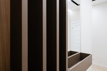 bright corridor with dark wooden furniture and a mirror