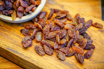 There are many naturally dried red raisins on the table