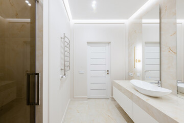 Naklejka na ściany i meble bathroom interior design with light tiles and glass shower