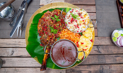 Sheep leg cooked over charcoal in India