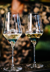 Two glasses of cold dry white wine on bar