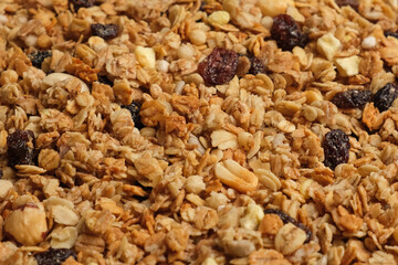 Muesli Background. Homemade Granola Filling full Frame. Top view, close up. Dry Muesli Mix Pile Rotating on Turntable. Abstract Cereal Grain Pattern, Texture. Multigrain Wallpaper. Proper nutrition