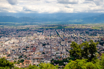 Cerro San Bernardo viewpoint over the city of Salta in Argentina. Along straight streets, buildings extend through the valley.
