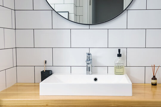 Minimalist bathroom interior, modern faucet and sink