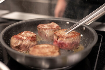 fillet of meat being cooked