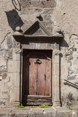 Belle porte ancienne datée de 1700 dans le village auvergnat de Salers (Cantal) - obrazy, fototapety, plakaty