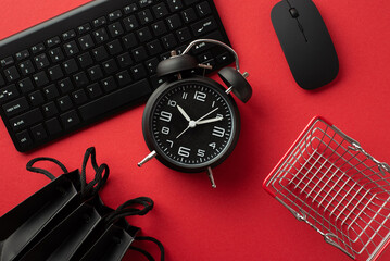 Black friday concept. Top view photo of black alarm clock computer mouse keyboard shopping cart and...