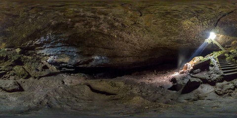 Stalbitsata cave meaning the stair, with a hole on the ceiling. Between heaven and hell concept. It...