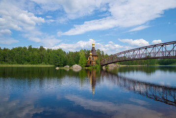Fototapeta na wymiar Summer landscape with Vuoksa river and Church of St. Andrew the First-Called. Leningrad region, Russia
