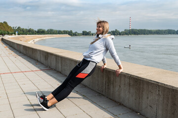 Young woman cancer survivor decides to change her way of life after illness and start practicing every morning as new life routine. Female workout training outdoor for health and happiness.