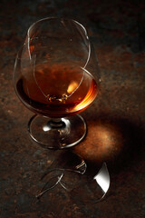 Brandy is in broken glass on a rusty background.