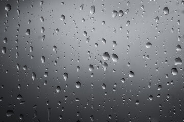 Close-up of rain drops on glass background. Premium colorful abstract background with dynamic shadow on background, consisting of water on glass, gradient color, artistic texture, epic, beautiful