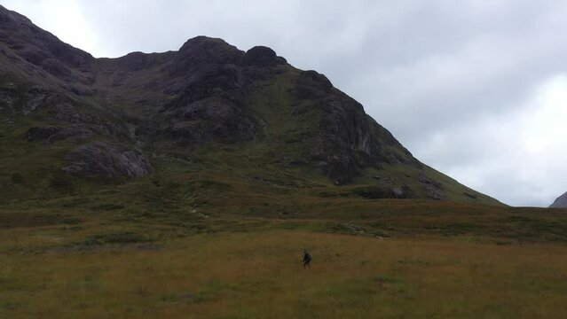 Aerial Video of a Hiker on the beautifully dramatic Buachaille Etive Mor, on a Grey cloudy day in the Scottish Highlands - Scotlands Famous Mountain