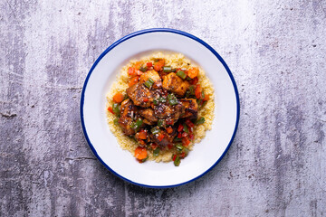 Marinated chicken with vegetables and couscous. Traditional African recipe.