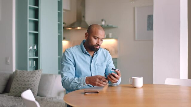 Smartphone, credit card and man check time on his watch for easy payment or digital bank notification on mobile app. Fintech entrepreneur or black man at home waiting for online credit score results