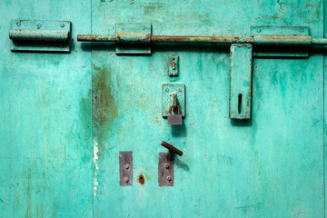Old grunge metal door with padlock