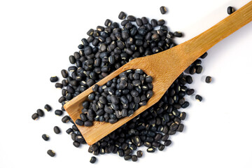 Black Lentils (Maa de Daal, Black matpe beans, Urad whole). Black Lentils with wooden spoon on white background