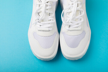 White sneakers on a colored background.Fashion.UNISEX. Sneakers are sports shoes for an active lifestyle. Product photo and levitation concept. Street style. Copy space. Place for text.