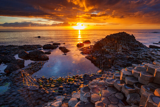 sunset over the sea at Gaint&acute;s Causeway in Ireland