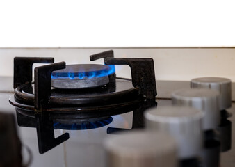 close up of a gas stove,Burning blue flame cooktop used for cooking in the kitchen. Electricity, natural gas or tube stoves, expensive energy.Selective focus.Noise effect