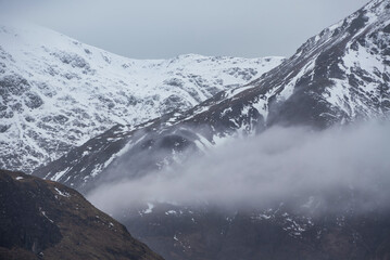 Beautiful Winter landscape image of snowcapped peak of Stob Dearg Buachaille Etive Mor in Glencoe, Rannoch Moor