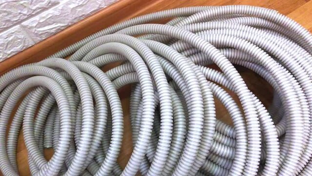 Corrugated pipes for electrical wire lie on the floor in the house during repairs