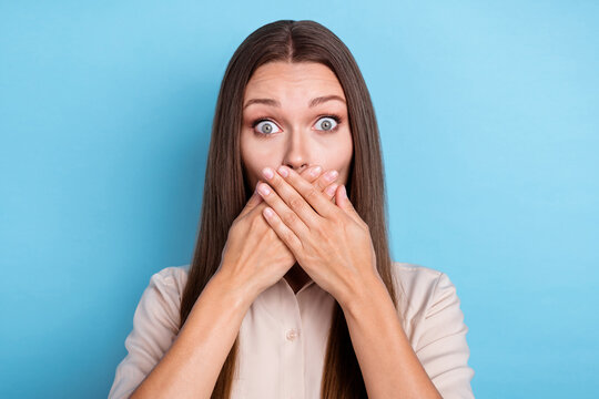 Photo portrait of stunning young woman hands cover mouth astonished news wear stylish smart casual look isolated on blue color background