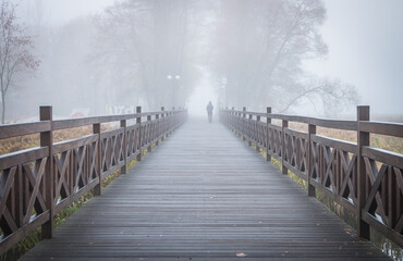 bridge over the river in the misty morning