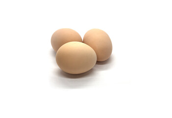 Three chicken eggs on a white background