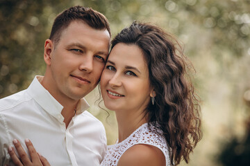 Fototapeta premium Beautiful happy couple in love man and woman, portrait in nature close-up