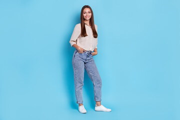 Full body photo of hr young lady stand wear grey shirt jeans boots isolated on blue color background