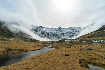 lagoon between snow-capped mountains of sierra de gredos