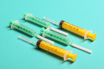 Top view of different syringes at blue background. Medical injection concept with copy space