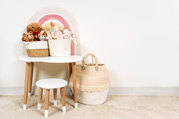 White table with rainbow and toys Storage Baskets in children's room. Nursery Storage Ideas.