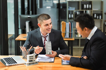 Salesman Hands On House Model , Small Toy House Small Mortgage Property insurance and concepts real estate